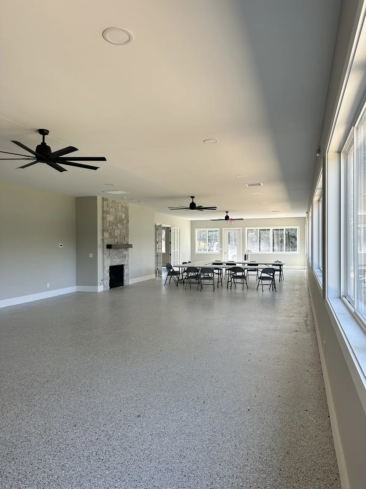 The activity center interior, fireplace and lake-view windows