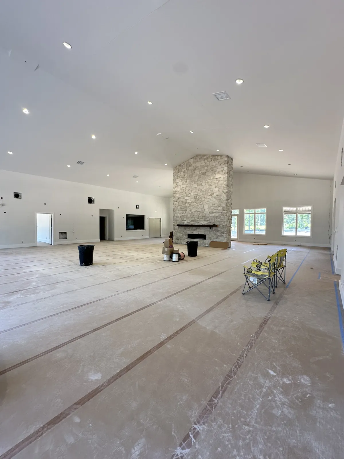 Inside the lodge great room, stone fireplace and vaulted ceiling
